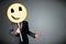 Businessman holding a smiley face emoticon