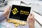 Businessman holding tablet with logo of cryptocurrency decentralized exchange protocol Binance Smart Chain. Trading blockchain