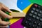 Businessman holding a wooden block in his hand next to a calculator and color charts. Planning,risk and project management