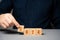 Businessman holding wooden blocks 2024. Business plan and strategy concept. Planning. Targets and goals. Financial plans,