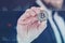 Businessman holds a gold bitcoin coin in his hands. Information holographic panel with statistics shows the fall and growth of the