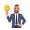Businessman holds a light bulb in his hand. Man has an idea. Portrait of a happy person. Smart white guy with an idea of how to