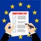 A businessman holds a list of sanctions against the backdrop of the European Union. Prohibition, restriction checklist symbol.