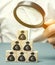 Businessman holds magnifying glass over cubes with euro. Analysis of profits and revenues in the company. Distribution of money.