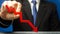 Businessman holds a red down arrow. The concept of reducing profits and income. Recession and the financial crisis. Capital