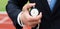 Businessman holds stopwatch and measures the elapsed time