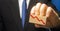 Businessman holds wooden block with red down arrow. The concept of reducing profits and income. Recession and the financial crisis