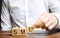 Businessman holds wooden blocks with the word SME. Small and medium-sized enterprises - commercial enterprises that do not exceed