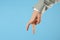 Businessman imitating walk with hand on light blue background, closeup. Finger gesture