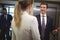 Businessman interacting with his female colleague near elevator