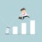 Businessman jump spring across the growing bar chart. Growth for business concept.