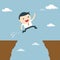 Businessman jumping over the cliff to goal