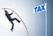 Businessman jumping over tax in tax evasion avoidance concept