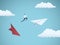 Businessman jumping between paper planes. Business symbol or metaphor for risk, danger, change, escape or bankruptcy and