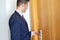 Businessman with keycard at hotel or office door