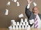 Businessman Knocking Down Pyramid Of Cups