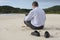 Businessman with laptop on the beach