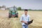 Businessman with laptop in field