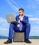 Businessman with laptop sit briefcase blue sky background. Laptop indispensable attribute modern businessman. Modern