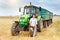 Businessman with laptop and tractor