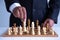 Businessman leadership hand moving of playing chess   concept: symbol confident new strategy plan for win and success,  sports gam