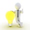 Businessman leaning on light bulb