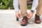 Businessman with leather shoes tying shoe laces