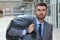 Businessman leaving office with full black plastic bag