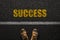 Businessman legs with shoes goes on the asphalt with yellow text Success, top view. Career development concept