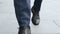 Businessman legs walking on city street.Entrepreneur wearing black leather shoes