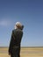 Businessman Listening Music On Radio In Desert