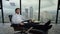 Businessman looking at business papers in office. Employee sitting in chair