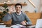 Businessman looking at camera, smiling and showing okay sign at table