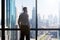 Businessman Looking At Cityscape Through Window