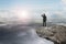 businessman looking on cliff with natural sky daylight cloudscape