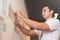 Businessman looking documents on wall