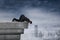 Businessman looking down from the rooftop