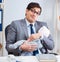 Businessman looking after newborn baby in office