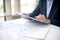 businessman looking at paper work on the table his hand