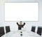 Businessman looks at blank poster on the wall in modern conference room, mock up