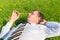 Businessman lying on the grass