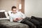 Businessman lying on hotel bed after long and tiring flight
