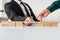 Businessman making a bridge of wooden blocks for his partner