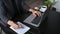 Businessman making notion notebook and using laptop at office desk.