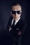 Businessman man in black suit and sunglasses on dark background