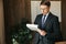 Businessman man in glasses, writes down the paperwork in the office