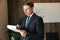 Businessman man in glasses, writes down the paperwork in the office