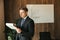 Businessman man in glasses, writes down the paperwork in the office