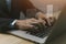 Businessman managing electronic documents on the laptop.