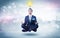 Businessman meditates with enlightenment concept
